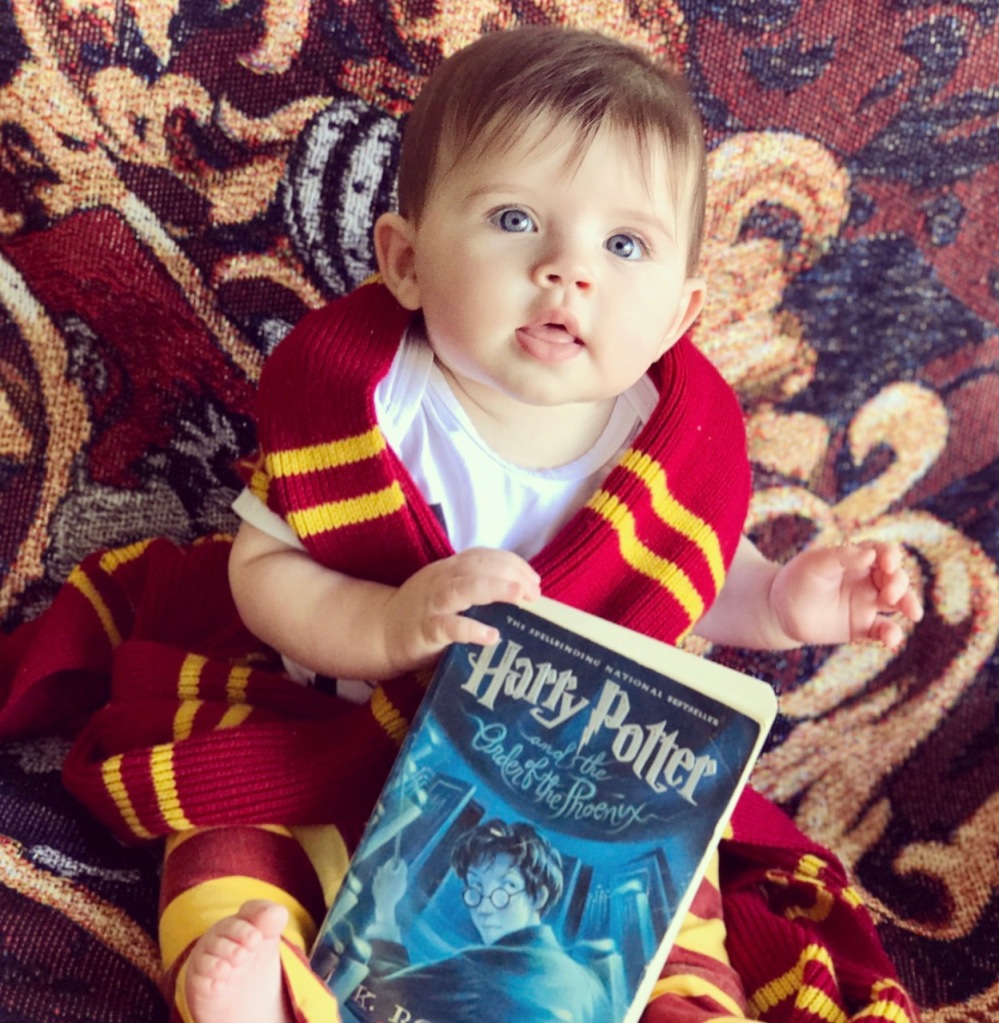 My daughter holding the order of the phoenix book